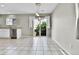 Open dining area with tiled floors, sliding glass doors to the outside, and modern light fixture at 11803 W Tufts Pl, Morrison, CO 80465