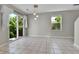 Bright dining area with tiled floors, sliding doors to the backyard, and pendant lighting at 11803 W Tufts Pl, Morrison, CO 80465