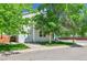 Charming two-story home with attached garage, mature trees, and a well-maintained front yard at 11803 W Tufts Pl, Morrison, CO 80465