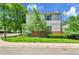 Well-maintained two-story home features a manicured lawn, lush landscaping, and a welcoming exterior at 11803 W Tufts Pl, Morrison, CO 80465