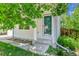 Inviting front entrance with a glass door, concrete steps, and surrounded by mature landscaping at 11803 W Tufts Pl, Morrison, CO 80465