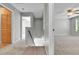A view of a carpeted hallway connecting multiple rooms, featuring neutral paint and a staircase at 11803 W Tufts Pl, Morrison, CO 80465
