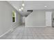 Open-concept living area with tiled floors, neutral walls, and ample natural light at 11803 W Tufts Pl, Morrison, CO 80465
