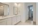 Modern bathroom featuring double sinks, a spacious vanity, and contemporary finishes at 661 Sunrise St, Erie, CO 80516