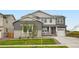 Charming two-story home boasts a manicured lawn, stone accents, and a welcoming front porch at 661 Sunrise St, Erie, CO 80516