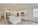 Spacious kitchen with an island, stainless steel appliances, and plenty of white cabinets at 661 Sunrise St, Erie, CO 80516