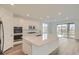 Bright, modern kitchen features a large island, stainless steel appliances, and ample cabinet space at 661 Sunrise St, Erie, CO 80516