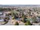 An aerial view shows a neighborhood with mature trees and well-maintained lawns in a suburban setting at 391 Burgess Dr, Castle Rock, CO 80104