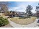Large backyard features a deck, patio, grass, and walkway at 391 Burgess Dr, Castle Rock, CO 80104