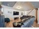 Finished basement features a large television, wood-look flooring, and stairs to the main floor at 391 Burgess Dr, Castle Rock, CO 80104