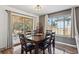 Stylish dining room with a wooden table and chairs, a modern light fixture, and sliding glass doors to the patio at 391 Burgess Dr, Castle Rock, CO 80104