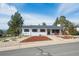 Attractive single-story home featuring a well-maintained lawn and inviting front porch at 391 Burgess Dr, Castle Rock, CO 80104