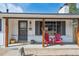 Charming front porch with rustic wood columns and bright red Adirondack chairs, offering a welcoming curb appeal at 391 Burgess Dr, Castle Rock, CO 80104