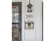 Close-up of the house number '391' with stylish outdoor lighting and decorative potted plants at 391 Burgess Dr, Castle Rock, CO 80104