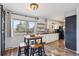 Eat-in kitchen with a square table, four chairs, and view of the backyard at 391 Burgess Dr, Castle Rock, CO 80104