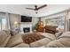 Cozy living room featuring a fireplace, a large sectional sofa, and a vintage piano, perfect for relaxation at 391 Burgess Dr, Castle Rock, CO 80104