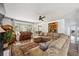 Open-concept living room featuring a cozy sectional sofa, a vintage piano, and hardwood floors at 391 Burgess Dr, Castle Rock, CO 80104