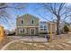 Spacious backyard with a brick patio, grass, landscaping, and the home's exterior at 10157 W Fremont Pl, Littleton, CO 80127