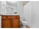 Well-lit bathroom featuring a vanity, sink, toilet, and shower with curtain at 10157 W Fremont Pl, Littleton, CO 80127