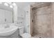 Beautiful bathroom featuring a stand up shower with tan and brown tile and white vanity at 10157 W Fremont Pl, Littleton, CO 80127