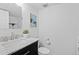 Modern bathroom with marble counter tops, dark cabinets and new toilet at 10157 W Fremont Pl, Littleton, CO 80127
