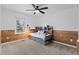 Bright bedroom with a ceiling fan, wood accents, and a large window at 10157 W Fremont Pl, Littleton, CO 80127