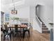 Dining room with rustic wood table and skylight, leading to staircase with white railings at 10157 W Fremont Pl, Littleton, CO 80127