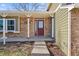 Home's entrance features a covered porch, brick facade, and a neatly paved walkway at 10157 W Fremont Pl, Littleton, CO 80127