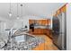 Bright kitchen with wood cabinets, granite counters and stainless steel appliances at 10157 W Fremont Pl, Littleton, CO 80127