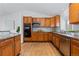 Kitchen with wood cabinets, granite countertops, stainless steel appliances and ample counter space at 10157 W Fremont Pl, Littleton, CO 80127