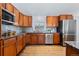 Kitchen with wood cabinets, granite counters, stainless steel appliances and tile backsplash at 10157 W Fremont Pl, Littleton, CO 80127