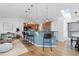 Open-concept living space with a breakfast bar, hardwood floors, and natural lighting at 10157 W Fremont Pl, Littleton, CO 80127