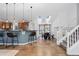 Bright living space with hardwood floors, breakfast bar, and stairs leading up to other floors at 10157 W Fremont Pl, Littleton, CO 80127