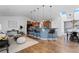 Bright, open living space with a breakfast bar, hardwood floors, and modern lighting fixtures at 10157 W Fremont Pl, Littleton, CO 80127