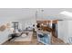 Open-concept living room and kitchen with modern appliances, pendant lighting and breakfast bar seating at 10157 W Fremont Pl, Littleton, CO 80127