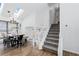 Bright dining room leads to staircase with white railings and carpeted stairs and skylight at 10157 W Fremont Pl, Littleton, CO 80127