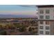 Modern building exterior with city skyline and mountain views in the background at 5455 Landmark Pl # 1106, Greenwood Village, CO 80111