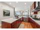 Kitchen features modern appliances, wine fridge, and opens to living and dining area at 5455 Landmark Pl # 1106, Greenwood Village, CO 80111
