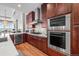 Gourmet kitchen boasts stainless steel appliances, wine fridge, and sleek, modern design at 5455 Landmark Pl # 1106, Greenwood Village, CO 80111