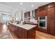 Modern kitchen with stainless steel appliances, large island, and beautiful wood cabinets at 5455 Landmark Pl # 1106, Greenwood Village, CO 80111