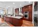 Modern kitchen with stainless steel appliances, large island, and beautiful wood cabinets at 5455 Landmark Pl # 1106, Greenwood Village, CO 80111