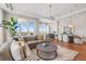 Open-concept living area with large sectional, expansive windows, and dining area with views at 5455 Landmark Pl # 1106, Greenwood Village, CO 80111