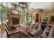 Elegant living room featuring a stone fireplace, large windows, and a decorative chandelier at 5455 Landmark Pl # 1106, Greenwood Village, CO 80111