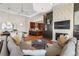 Open-concept living area with kitchen, fireplace, and large sectional, with abundant natural light at 5455 Landmark Pl # 1106, Greenwood Village, CO 80111
