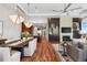 Open concept living area with dining space and kitchen featuring hardwood flooring and modern lighting at 5455 Landmark Pl # 1106, Greenwood Village, CO 80111