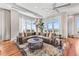 Bright living room with large sectional, area rug, and stunning outdoor views at 5455 Landmark Pl # 1106, Greenwood Village, CO 80111