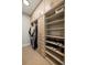 Well-organized walk-in closet with ample storage space, custom shelving, and hanging rods at 5455 Landmark Pl # 1106, Greenwood Village, CO 80111