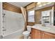 Bathroom features shower/tub combo, modern fixtures, and wallpapered accent wall at 2357 Morningview Ln, Castle Rock, CO 80109