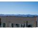 A rooftop view of a snow-capped mountain range with blue skies and a clear glass balcony at 5125 W 29Th Ave # 5, Denver, CO 80212