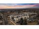 Stunning aerial view of 5125 W 29th #5 highlighting its rooftop decks and proximity to the city, set against a vibrant sunset at 5125 W 29Th Ave # 5, Denver, CO 80212